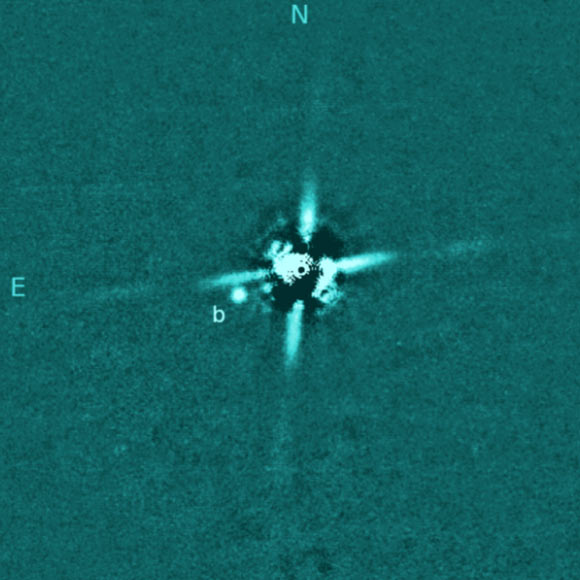 This image from the Subaru Telescope shows the young super-Jupiter 2M0437b, which lies about 100 times the Earth-Sun distance from its parent star; the much-brighter star has been mostly removed, and the four ‘spikes’  are artifacts produced by the optics of the telescope. Image credit: Subaru Telescope / Gaidos et al., arXiv: 2110.08655.