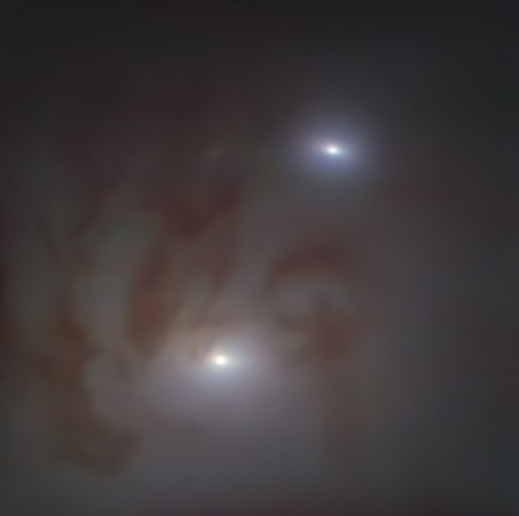 This image, taken with the MUSE instrument on ESO’s Very Large Telescope, shows two bright galactic nuclei, each housing a supermassive black hole, in NGC 7727. Image credit: ESO / Voggel et al.