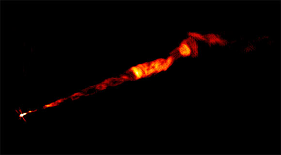 VLA image of the Messier 87 radio jet, made at multiple radio frequencies. The jet seen in this image is about 8,000 light-years long. This image clearly shows the corkscrew-like helical structure in the inner part of the jet, which originates at the bright spot at the left, at the core of the galaxy, where a supermassive black hole resides. Image credit: Sophia Dagnello / NRAO / AUI / NSF / Pasetto et al., doi: 10.3847/2041-8213/ac3a88.
