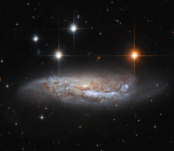 This Hubble image shows NGC 3568, a barred spiral galaxy some 57 million light-years away in the constellation of Centaurus. The color image is made up of observations from Hubble’s Wide Field Camera 3 (WFC3) and Advanced Camera for Surveys (ACS) instruments in the ultraviolet, near-infrared, and optical parts of the spectrum. It is based on data obtained through three filters. The color results from assigning different hues to each monochromatic image associated with an individual filter. Image credit: NASA / ESA / Hubble / M. Sun.