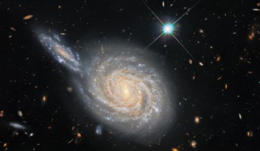 This image, taken with the NASA/ESA Hubble Space Telescope, depicts NGC 105, a spiral galaxy 215.5 million light-years away in the constellation of Pisces, and a smaller distant galaxy. Image credit: NASA / ESA / Hubble / D. Jones / Riess et al. / R. Colombari.