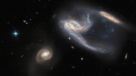 This image shows NGC 7764A, a group of three galaxies located 425 million light-years away in the constellation of Phoenix. The color image is made up of observations from Hubble’s Advanced Camera for Surveys (ACS) and the Dark Energy Camera (DECam) on the Victor M. Blanco 4-m Telescope in the near-infrared and optical parts of the spectrum. Image credit: NASA / ESA / Hubble / J. Dalcanton, Dark Energy Survey / DOE / FNAL, DECam / CTIO / NOIRLab / NSF / AURA / ESO / Judy Schmidt, www.geckzilla.com.