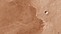 This image from the Context Camera onboard NASA’s Mars Reconnaissance Orbiter shows Bosporos Planum on Mars; the white specks are salt deposits found within a dry channel; the largest impact crater in the scene is nearly 1.5 km (one mile) across. Image credit: NASA / JPL-Caltech / MSSS.