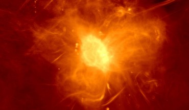 The complex, cirrus-like emission from the Galactic center super bubble dominates this MeerKAT image. This is traversed by the Radio Arc, a complex of many parallel radio filaments. The radio bubble nestles against the diffuse Sagittarius A region in the lower center of the image. The bright dot near the center of this region is Sagittarius A*. Image credit: I. Heywood, SARAO.