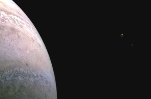 This Juno image shows Jupiter, Io and Europa (from left to right). Image credit: NASA / JPL-Caltech / SwRI / MSSS / Andrea Luck.