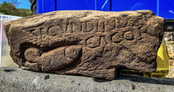 The ancient carved stone with the image of a phallus and graffiti found at the site of Vindolanda in Northumberland, England. Image credit: Vindolanda Trust.