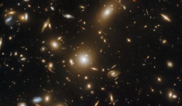 This Hubble image shows the massive galaxy cluster Abell 1351. The color image was made from separate exposures taken in the visible and near-infrared regions of the spectrum with Hubble’s Wide Field Camera 3 (WFC3) and Advanced Camera for Surveys (ACS). Several filters were used to sample various wavelengths. The color results from assigning different hues to each monochromatic image associated with an individual filter. Image credit: NASA / ESA / Hubble / H. Ebeling / L. Shatz.