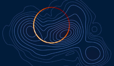 The emission from M87* has been resolved into a bright, thin ring (orange colormap), arising from the infinite sequence of additional images of the emission region, and the more diffuse primary image, produced by the photons that come directly toward Earth (in blue contours); when viewed at the imaging resolution of the Event Horizon Telescope, the two components blur together; however, by separately searching for the thin ring, it is possible to sharpen the view of M87*, isolating the fingerprint of strong gravity. Image credit: Broderick et al., doi: 10.3847/1538-4357/ac7c1d.