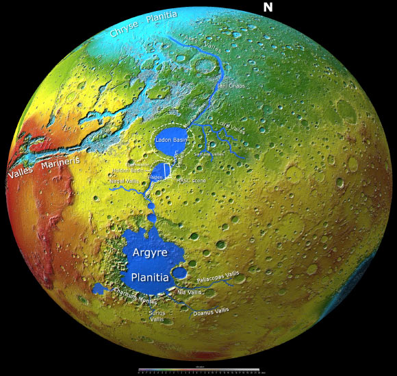 This image was created using data from the Mars Orbiter Laser Altimeter (MOLA) instrument on NASA’s Mars Global Surveyor mission. It shows the complete Uzboi-Ladon-Morava outflow system. The area outlined by the bold white box indicates part of the Holden Basin, which was imaged by the Mars Express High Resolution Stereo Camera on April 24, 2022, during orbit 23133. The dashed circles depict the informally named Holden and Ladon Basins. Image credit: MOLA Science Team / FU Berlin / CC BY-SA 3.0 IGO.