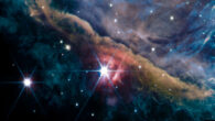 The inner region of the Orion Nebula as seen by the NIRCam instrument on board the NASA/ESA/CSA James Webb Space Telescope. This is a composite image from several filters that represents emission from ionized gas, hydrocarbons, molecular gas, dust and scattered starlight. Most prominent is the Orion Bar, a wall of dense gas and dust that runs from the top left to the bottom right in this image, and that contains the bright star θ2 Orionis A. The scene is illuminated by a group of hot, young massive stars -- known as the Trapezium Cluster -- that is located just off the top right of the image. The strong and harsh ultraviolet radiation of the Trapezium cluster creates a hot, ionized environment in the upper right, and slowly erodes the Orion Bar away. Molecules and dust can survive longer in the shielded environment offered by the dense Bar, but the surge of stellar energy sculpts a region that displays an incredible richness of filaments, globules, young stars with disks and cavities. Image credit: NASA / ESA / CSA / PDRs4All ERS Team / Salomé Fuenmayor.