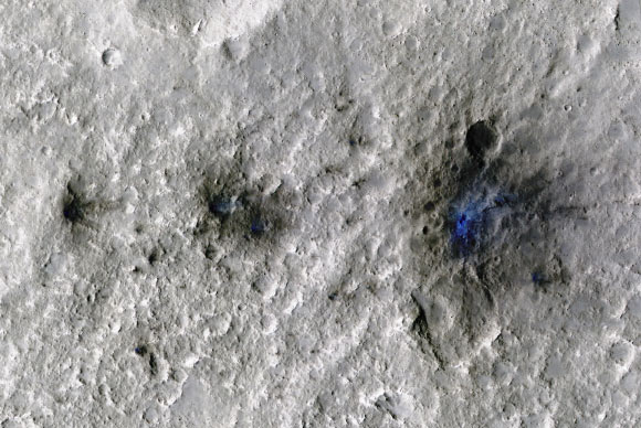 These craters were formed by a meteoroid impact on Mars on September 5, 2021, the first to be detected by NASA’s InSight lander; taken by NASA’s Mars Reconnaissance Orbiter, this enhanced-color image highlights the dust and soil disturbed by the impact in blue in order to make details more visible to the human eye. Image credit: NASA / JPL-Caltech / University of Arizona.