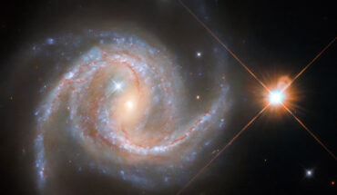 This Hubble image shows NGC 5495, a spiral galaxy some 319 million light-years away in the constellation of Hydra. The color image was made from separate exposures taken in the visible and infrared regions of the spectrum with Hubble’s Wide Field Camera 3 (WFC3). Five filters were used to sample various wavelengths. The color results from assigning different hues to each monochromatic image associated with an individual filter. Image credit: NASA / ESA / Hubble / J. Greene / R. Colombari.