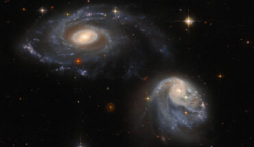 This Hubble image shows the galaxy pair Arp-Madore 608-333. The color image is composed of near-infrared and optical observations from Hubble’s Advanced Camera for Surveys (ACS) and the Dark Energy Camera (DECam) on the Victor M. Blanco 4-m Telescope. Four filters were used to sample various wavelengths. The color results from assigning different hues to each monochromatic image associated with an individual filter. Image credit: NASA / ESA / Hubble / Dark Energy Survey / DOE / FNAL / DECam / CTIO / NOIRLab / NSF / AURA / J. Dalcanton.