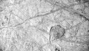 This Juno photo of the surface of Europa reveals a curious feature surrounded by a vast network of linear ridges and dark blotches. It was obtained by Juno’s Stellar Reference Unit (SRU) during the spacecraft’s September 29, 2022, flyby of Europa at a distance of about 412 km. Image credit: NASA / JPL-Caltech / SwRI.