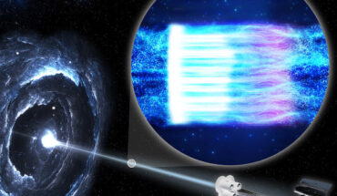 This illustration shows the IXPE spacecraft (right) observing the blazar Markarian 501 (left). A blazar is a black hole surrounded by a disk of gas and dust with a bright jet of high-energy particles pointed toward Earth. The inset illustration shows high-energy particles in the jet (blue). When the particles hit the shock wave, depicted as a white bar, the particles become energized and emit X-rays as they accelerate. Moving away from the shock, they emit lower-energy light: first visible, then infrared, and radio waves. Farther from the shock, the magnetic field lines are more chaotic, causing more turbulence in the particle stream. Image credit: NASA / Pablo Garcia.