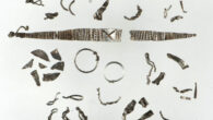 The Viking-age hoard consists of 46 silver objects; apart from two simple, complete finger rings, it includes Arab coins, a braided necklace, several bracelets and chains, all broken into small pieces. Image credit: Birgit Maixner.