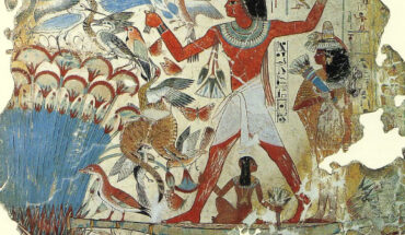 Fragment of a polychrome tomb-painting (before 1350 BCE, today in the British Museum) representing Nebamun, standing in a small boat, fowling and fishing in the marshes, his wife stands behind and his daughter sits beneath, he holds a throw-stick in one hand and three decoy herons in the other, his cat is shown catching three of the numerous birds. Image credit: Marcus Cyron / British Museum.