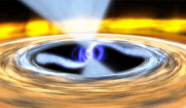 A neutron star (blue sphere) spins in the center of a colorful disk of gas, some of which follows the magnetic field (blue lines) and flows (blue-white arcs) onto the object’s surface. Image credit: NASA’s Goddard Space Flight Center Conceptual Image Lab.