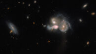 This Hubble image shows SDSSCGB 10189, a trio of merging galaxies located in the constellation of Boötes. Further to the left is an unconnected, dimmer spiral galaxy. Image credit: NASA / ESA / Hubble / M. Sun.