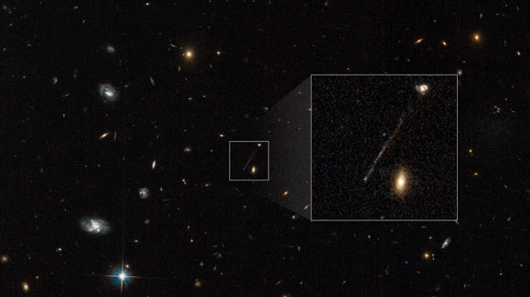 This archival Hubble photo captures a curious linear feature that is so unusual it was first dismissed as an imaging artifact from the telescope’s cameras. But follow-up spectroscopic observations reveal it is a 200,000-light-year-long chain of young blue stars. A supermassive black hole lies at the tip of the bridge at lower left. The black hole was ejected from the galaxy at upper right. It compressed gas in its wake to leave a long trail of young blue stars. Nothing like this has ever been seen before in the Universe. This unusual event happened when the Universe was approximately half its current age. Image credit: NASA / ESA / Pieter van Dokkum, Yale University / Joseph DePasquale, STScI.