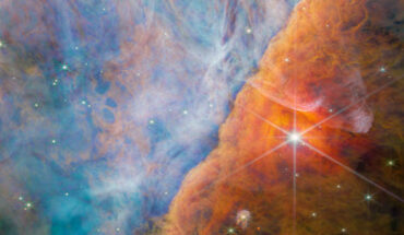 This image taken by Webb’s Near-Infrared Camera shows a part of the Orion Nebula known as the Orion Bar. It is a region where energetic ultraviolet light from the Trapezium Cluster -- located off the upper-left corner -- interacts with dense molecular clouds. The energy of the stellar radiation is slowly eroding the Orion Bar, and this has a profound effect on the molecules and chemistry in the protoplanetary disks that have formed around newborn stars here. Image credit: NASA / ESA / CSA / Webb / M. Zamani / PDRs4All ERS Team.