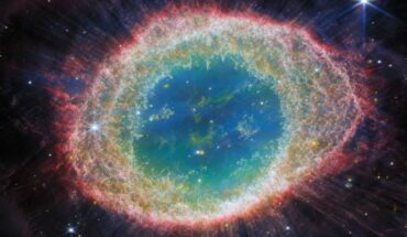 This image from Webb’s NIRCam instrument shows the Ring Nebula. The nebula’s inner cavity hosts shades of blue and green, while the detailed ring transitions through shades of orange in the inner regions and pink in the outer region. The ring’s inner region has distinct filament elements. Image credit: NASA / ESA / CSA / Webb / M. Barlow / N. Cox / R. Wesson.