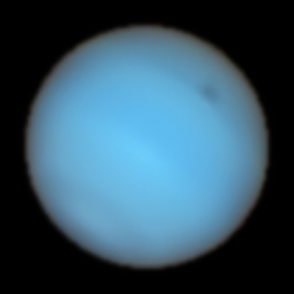 This image from the MUSE instrument on ESO’s Very Large Telescope shows Neptune; a dark spot can be seen to the upper-right. Image credit: ESO / Irwin et al.