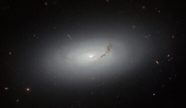 This Hubble image shows NGC 3156, a large lenticular galaxy some 73 million light-years away in the constellation of Sextans. The color image includes optical and near-infrared observations from Hubble’s Advanced Camera for Surveys (ACS) and Wide Field Camera 3 (WFC3) instruments. It is based on data obtained through three filters. The color results from assigning different hues to each monochromatic image associated with an individual filter. Image credit: NASA / ESA / Hubble / R. Sharples / S. Kaviraj / W. Keel.