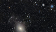 This DEC image shows the onion-like layers of NGC 3923, a shell galaxy some 70 million light-years away in the constellation of Hydra. The image also shows the face-on spiral galaxies LEDA 744285 and ESO 440-11; and near the top of the image is the extremely large gravitational lens around the galaxy cluster PLCK G287.0+32.9. Image credit: DESI Legacy Imaging Surveys / LBNL / DOE / KPNO / CTIO / NOIRLab / NSF / AURA / T.A. Rector, University of Alaska Anchorage / NSF’s NOIRLab / M. Zamani, NSF’s NOIRLab / R. Colombari, NSF’s NOIRLab / D. de Martin, NSF’s NOIRLab.