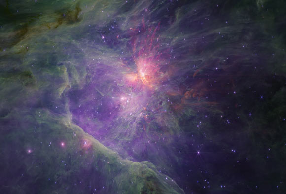 This image from Webb’s NIRCam long-wavelength channel reveals the gas, dust and molecules in the Orion Nebula with unprecedented sensitivity in infrared, but at lower spatial resolution than in the short-wavelength image. The cavity is mostly filled with ionized gas, seen here in purple, while the surroundings have a mix of dust and molecular gas seen in reds, browns, and greens. The Bright Bay to the upper left is being eroded by the massive stars and there are many pillars of gas and dust which are being carved. Image credit: NASA / ESA / CSA / M. McCaughrean / S. Pearson.