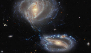This Hubble image shows Arp-Madore 2339-661, a group of three interacting galaxies some 500 million light-years away in the constellation of Tucana. The color image was made from separate exposures taken in the visible and infrared regions of the spectrum with Hubble’s Advanced Camera for Surveys (ACS) and the Dark Energy Camera (DECam) on the Víctor M. Blanco 4-m telescope at Cerro Tololo Inter-American Observatory. Four filters were used to sample various wavelengths. The color results from assigning different hues to each monochromatic image associated with an individual filter. Image credit: NASA / ESA / Hubble / J. Dalcanton, Dark Energy Survey / DOE / FNAL / NOIRLab / NSF / AURA / L. Shatz.