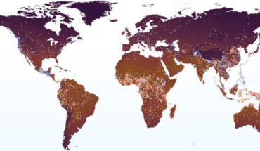Global distribution of MSIs across 9,179 language varieties from the ASJP database. Color of dots represents the MSI of the language, with redder dots indicating higher and bluer dots indicating lower indices. The fill color of land areas represents the mean annual temperature. Image credit: Wang et al., doi: 10.1093/pnasnexus/pgad384.