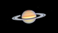 This Hubble image shows Saturn, its bright white rings, and its three moons: Mimas, Dione, and Enceladus; spoke features on the left and right sides of the rings appear like faint gray smudges against the rings’ bright backdrop, about midway from the planet to the rings’ outer edge. Image credit: NASA / ESA / Hubble / STScI / Amy Simon, NASA’s Goddard Space Flight Center.