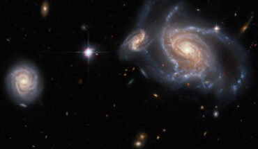 This Hubble image shows four spiral galaxies in the constellation of Horologium: the large, prominent spiral galaxy on the right side of the image is NGC 1356; the two apparently smaller spiral galaxies flanking it are LEDA 467699 (above it) and LEDA 95415 (very close at its left) respectively; and finally, IC 1947 sits along the left side of the image. Image credit: NASA / ESA / Hubble / J. Dalcanton, Dark Energy Survey / DOE / FNAL / NOIRLab / NSF / AURA / L. Shatz.
