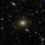 This Hubble image shows various distant galaxies in the constellation of Cetus: most of the galaxies are very small, but there are a few larger galaxies and some stars where detail can be made out; in the center there is an elliptical galaxy with a brightly glowing core and a broad disk; a reddish, warped ring of light, thicker at one side, surrounds its core; a small galaxy intersects the ring as a bright dot. Image credit: NASA / ESA / Hubble / H. Nayyeri / L. Marchetti / J. Lowenthal.