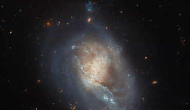 This Hubble image shows IC 3476, a dwarf spiral galaxy located 54 million light-years away in the constellation of Coma Berenices. This image is made up of observations from Hubble’s Advanced Camera for Surveys (ACS) in the near-infrared and optical parts of the spectrum. It is based on data obtained through two filters. The color results from assigning different hues to each monochromatic image associated with an individual filter. Image credit: NASA / ESA / Hubble / M. Sun.