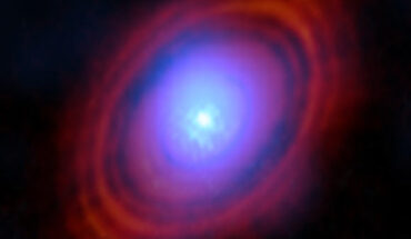 This ALMA image shows the water vapor (shades of blue) in the protoplanetary disk around HL Tauri; near the center of the disk, where the young star lives, the environment is hotter and the gas brighter; the red-hued rings are previous ALMA observations showing the distribution of dust around the star. Image credit: ALMA / ESO / NAOJ / NRAO / Facchini et al.