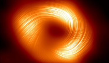 This image from the Event Horizon Telescope shows the polarized view of Sagittarius A*; the lines overlaid on this image mark the orientation of polarization, which is related to the magnetic field around the shadow of the black hole. Image credit: EHT Collaboration.