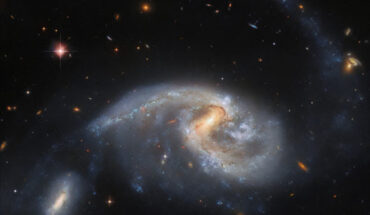 This image shows Arp 72, a galaxy pair that includes NGC 5996 (large spiral galaxy) and NGC 5994 (its smaller companion, in the lower left of the image). The color image was made from separate exposures taken in the visible and infrared regions of the spectrum with Hubble’s Advanced Camera for Surveys (ACS) and the Dark Energy Camera (DECam), which is mounted on NSF’s Víctor M. Blanco 4-m telescope at Cerro Tololo Inter-American Observatory in Chile. Four filters were used to sample various wavelengths. The color results from assigning different hues to each monochromatic image associated with an individual filter. Image credit: NASA / ESA / Hubble / L. Galbany / J. Dalcanton / Dark Energy Survey / DOE / FNAL / DECam / CTIO / NOIRLab / NSF / AURA.