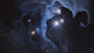 HP Tau, a trio of dazzling stars some 550 light-years away in the constellation of Taurus, blaze brilliantly from the hollowed-out cavity of a reflection nebula in the new Hubble image. Image credit: NASA / ESA / G. Duchene, Universite de Grenoble I / Gladys Kober, NASA & Catholic University of America.