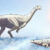 An artist’s impression of Musankwa sanyatiensis, walking in Triassic shallow waters past a metoposaur. Image credit: Atashni Moopen / Sci.News.