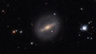 This Hubble image shows LEDA 12535, a barred spiral galaxy some 320 million light-years away in the constellation of Perseus. The color composite was assembled from images taken by Hubble’s Wide Field Camera 3 (WFC3) in ultraviolet, visible, and near-infrared light. It is based on data obtained through three filters. The color results from assigning different hues to each monochromatic image associated with an individual filter. Image credit: NASA / ESA / Hubble / I. Chilingarian.