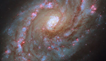 This Hubble image shows NGC 5248, a grand design spiral galaxy located some 42 million light-years away in the constellation of Boötes. The color image was made from separate exposures taken in the visible, ultraviolet and near-infrared regions of the spectrum with Hubble’s WFC3 instrument. Six filters were used to sample various wavelengths. The color results from assigning different hues to each monochromatic image associated with an individual filter. Image credit: NASA / ESA / Hubble / F. Belfiore / J. Lee / PHANGS-HST Team.