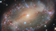 A prominent bar of stars stretches across the center of the barred spiral galaxy NGC 2566, and spiral arms emerge from each end of the bar. Image credit: NASA / ESA / Hubble / D. Thilker.