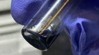 The purple/blue solution in this vial contains crystals of berkelocene. Image credit: Alyssa Gaiser / Berkeley Lab.