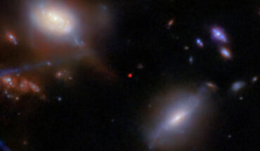 This image shows JADES-GS-z13-1 (the red dot at center), imaged with Webb’s Near-Infrared Camera (NIRCam) as part of the JADES program. Image credit: NASA / ESA / CSA / Webb / STScI / JADES Collaboration / Brant Robertson, UC Santa Cruz / Ben Johnson, CfA / Sandro Tacchella, Cambridge / Phill Cargile, CfA / J. Witstok, P. Jakobsen & A. Pagan, STScI / M. Zamani, ESA & Webb.