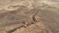 Aerial drone photograph showing the preserved stone section of the Gobi Wall traversing the hillside. Image credit: Golan et al., doi: 10.3390/land14051087.