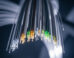 Petrovich et al. report a microstructured optical waveguide with unprecedented transmission bandwidth and attenuation. Image credit: Gemini AI.