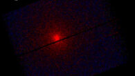 This XMM-Newton image shows an X-ray view of the interstellar comet 3I/ATLAS. At the center of the image, a bright red spot stands out against a dark background, like a fiery beacon. Starting from this core, faint gradients of purple and blue spread outward, creating a slightly rotated rectangular frame, divided by a thin horizontal line, the detector gap. The red color shows low-energy X-rays, blue marks empty space with very few X-rays. Image credit: ESA / XMM-Newton / C. Lisse / S. Cabot / XMM ISO Team.
