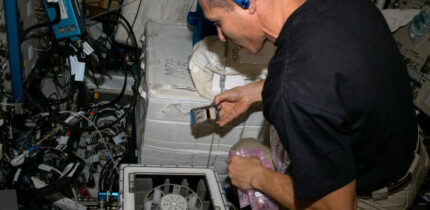 NASA astronaut Michael Scott Hopkins performs a microgravity experiment on the International Space Station. Image credit: NASA.